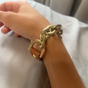 gold and brown chain and leather bracelet